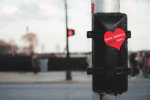 Street post with "Make America Love Again" heart sticker