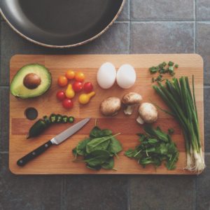 Patricia Moreno Breakfast: Avocado, eggs and vegetables on chopping board