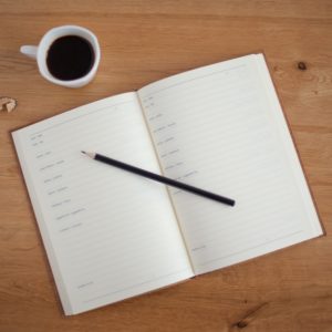 An updated approach to planning, notebook with pencil and coffee